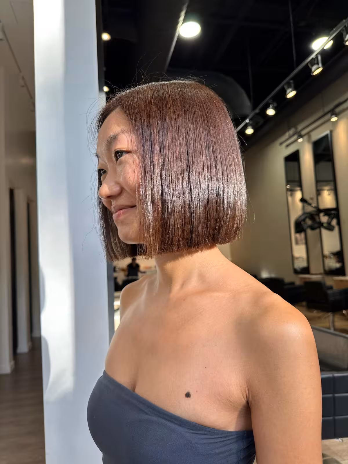 Sleek chocolate-brown blunt bob with glossy shine, side view - bob haircut Honolulu